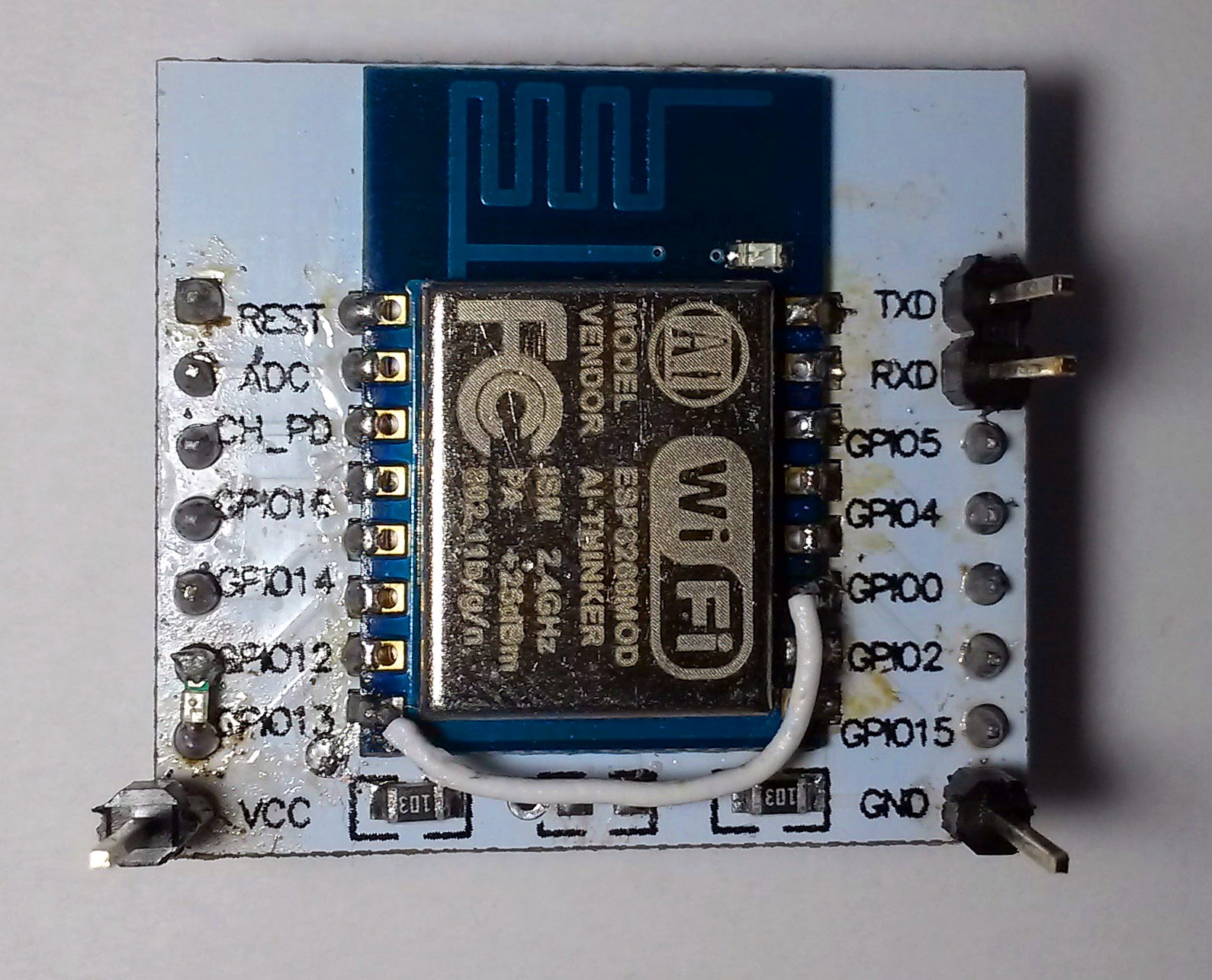 Top view on the assembled board. Single 0603 resistor and a piece of wire is needed to boot ESP from flash.